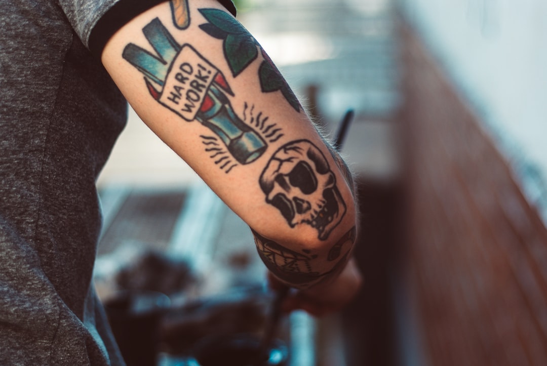 Photo Image: Tattoo artist Nouns: Tattoo, artist